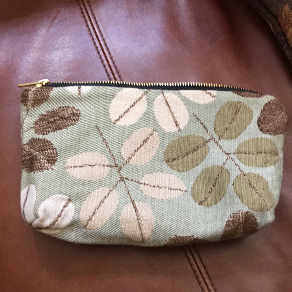 Neutral tapestry clutch or makeup bag.